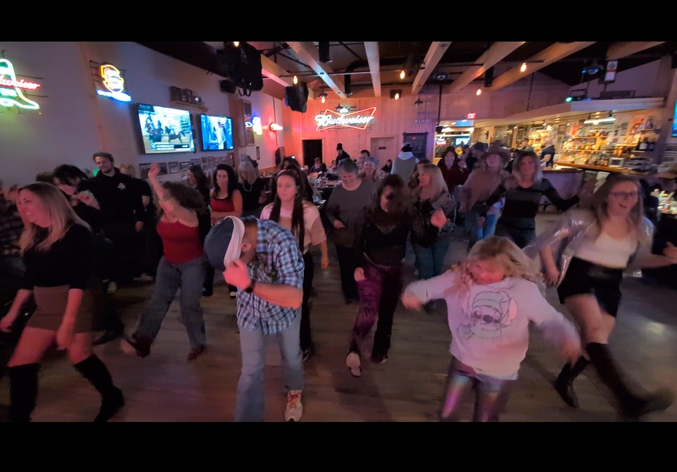 A packed line dance floor at Dad's Bar